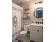 Updated bathroom features granite vanity, framed round mirror and decorative wall shelves at 1581 Shetland Pony Nw Ct, Suwanee, GA 30024