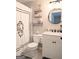 Updated bathroom features granite countertop, decorative shelving, and tiled floor at 1581 Shetland Pony Nw Ct, Suwanee, GA 30024