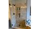 Close-up of walk-in shower with glass door, tile and built-in niche at 1581 Shetland Pony Nw Ct, Suwanee, GA 30024
