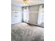 An empty bedroom featuring a ceiling fan, two windows, and neutral-colored carpet at 1581 Shetland Pony Nw Ct, Suwanee, GA 30024