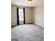 Empty bedroom with neutral carpet, a window with curtains, and light-colored walls at 1581 Shetland Pony Nw Ct, Suwanee, GA 30024