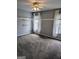 Neutral bedroom features plush carpeting, a ceiling fan, and natural light from two windows at 1581 Shetland Pony Nw Ct, Suwanee, GA 30024