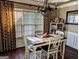 Elegant dining room with hardwood floors, stylish chandelier, and views of the outdoors at 1581 Shetland Pony Nw Ct, Suwanee, GA 30024