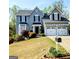 Charming two-story home with a manicured lawn, two-car garage, and attractive landscaping at 1581 Shetland Pony Nw Ct, Suwanee, GA 30024