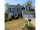Charming two-story home with manicured lawn, lush landscaping, and a two-car garage at 1581 Shetland Pony Nw Ct, Suwanee, GA 30024