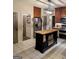 Well-equipped kitchen with dark wood cabinets, granite countertops, and a center island at 1581 Shetland Pony Nw Ct, Suwanee, GA 30024