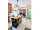 Open kitchen with island, granite countertops, hardwood floors, and seamless flow to the living room at 1581 Shetland Pony Nw Ct, Suwanee, GA 30024