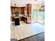 Spacious kitchen with tile flooring, a central island, and views of the backyard at 1581 Shetland Pony Nw Ct, Suwanee, GA 30024