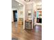 Open-concept living area with hardwood floors, decorative mirror, and seamless flow to the kitchen at 1581 Shetland Pony Nw Ct, Suwanee, GA 30024