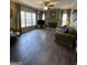 Bright living room with hardwood floors, fireplace, and large windows at 1581 Shetland Pony Nw Ct, Suwanee, GA 30024