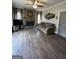 Spacious living room featuring fireplace and beautiful hardwood floors at 1581 Shetland Pony Nw Ct, Suwanee, GA 30024