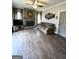 Cozy living room featuring hardwood floors, a fireplace, and comfortable sofa with blue pillows at 1581 Shetland Pony Nw Ct, Suwanee, GA 30024