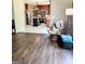 Open living space showcasing dark wood floors, leading to a kitchen with stainless steel appliances at 1581 Shetland Pony Nw Ct, Suwanee, GA 30024