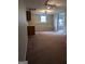 Inviting living room featuring neutral carpet, a window view, and great lighting at 1581 Shetland Pony Nw Ct, Suwanee, GA 30024