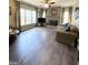 Spacious living room featuring a fireplace, large windows with curtains, and comfortable seating at 1581 Shetland Pony Nw Ct, Suwanee, GA 30024