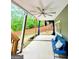Covered patio with ceiling fan and comfortable seating overlooking the yard at 1581 Shetland Pony Nw Ct, Suwanee, GA 30024