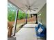 Covered patio featuring concrete, blue sofa with pillows and a ceiling fan at 1581 Shetland Pony Nw Ct, Suwanee, GA 30024