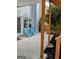 Cozy covered patio featuring concrete, mulched flower beds and two blue Adirondack chairs at 1581 Shetland Pony Nw Ct, Suwanee, GA 30024
