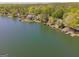 Wide aerial view of the lake showcasing the serene waters, shoreline, and surrounding wooded areas with waterfront houses at 1252 Heritage Dr, Villa Rica, GA 30180