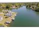 Aerial view of the lake and surrounding homes with private docks and boat houses, highlighting the waterfront lifestyle at 1252 Heritage Dr, Villa Rica, GA 30180