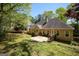Charming backyard with a spacious deck, grassy area, and a view of the home's exterior, perfect for gatherings at 1252 Heritage Dr, Villa Rica, GA 30180