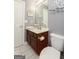 Bathroom with a brown vanity, sink and toilet with a shower and tub at 1252 Heritage Dr, Villa Rica, GA 30180