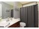 Bathroom with a brown vanity, sink and toilet with a shower and tub at 1252 Heritage Dr, Villa Rica, GA 30180