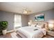 Cozy bedroom featuring neutral walls, ceiling fan, and abundant natural light from the large window at 1252 Heritage Dr, Villa Rica, GA 30180