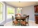 Sunlit breakfast nook features a view of the landscaped backyard at 1252 Heritage Dr, Villa Rica, GA 30180