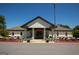 Exterior of a white community clubhouse with pillars, flower beds, and a parking area at 1252 Heritage Dr, Villa Rica, GA 30180