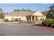 The community clubhouse with beige exterior, pillars, shrubbery, and asphalt driveway at 1252 Heritage Dr, Villa Rica, GA 30180