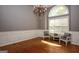 Formal dining room featuring hardwood floors, chandelier, chair railing, and large window at 1252 Heritage Dr, Villa Rica, GA 30180
