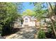 The house is nestled among lush green trees giving privacy from the street at 1252 Heritage Dr, Villa Rica, GA 30180