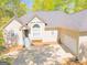 Traditional home showing garage and front entrance with landscaped yard and mature trees at 1252 Heritage Dr, Villa Rica, GA 30180