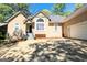 Exterior shot of ranch style home with attached garage, steps and landscaping at 1252 Heritage Dr, Villa Rica, GA 30180