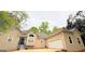 Beige home featuring an attached garage, front yard, and well-manicured landscaping at 1252 Heritage Dr, Villa Rica, GA 30180