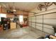 A spacious garage featuring a roll-up door, storage racks, and ample room for parking and organization at 1252 Heritage Dr, Villa Rica, GA 30180