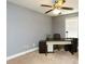 A well-lit home office features a ceiling fan, desk, and neutral color scheme perfect for working or studying at 1252 Heritage Dr, Villa Rica, GA 30180
