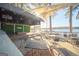 Scenic waterfront patio with a covered stage area, tables, and lush greenery overlooking the serene lake at 1252 Heritage Dr, Villa Rica, GA 30180