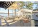 Outdoor waterfront patio with seating, offering picturesque views of the lake and surrounding trees at 1252 Heritage Dr, Villa Rica, GA 30180