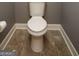 Toilet in the bathroom with tile flooring and clean, neutral design at 1252 Heritage Dr, Villa Rica, GA 30180