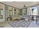 View of the outdoor back porch with comfortable couch, rug, and serene view at 608 White Cedar Ct, Peachtree City, GA 30269