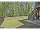 View of the spacious backyard with stairs leading up to the deck at 608 White Cedar Ct, Peachtree City, GA 30269