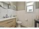 Half bathroom featuring a modern vanity, round mirror, stylish decor and a window for natural light at 608 White Cedar Ct, Peachtree City, GA 30269