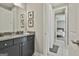 Bathroom featuring a dark vanity, shower with curtain, and a view into the adjacent bedroom at 608 White Cedar Ct, Peachtree City, GA 30269