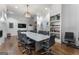 A modern conference room featuring hardwood floors, a fireplace, and a large table with rolling chairs at 608 White Cedar Ct, Peachtree City, GA 30269