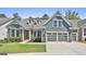 Charming blue two-story home with a well-manicured lawn and a two-car garage at 608 White Cedar Ct, Peachtree City, GA 30269