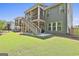 Exterior view of the house showcasing the elevated deck with staircase to the backyard at 608 White Cedar Ct, Peachtree City, GA 30269