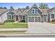 Charming blue two-story home with a well-manicured lawn and a two-car garage at 608 White Cedar Ct, Peachtree City, GA 30269