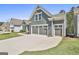 Three-car garage with a wide driveway and well-maintained landscaping at 608 White Cedar Ct, Peachtree City, GA 30269